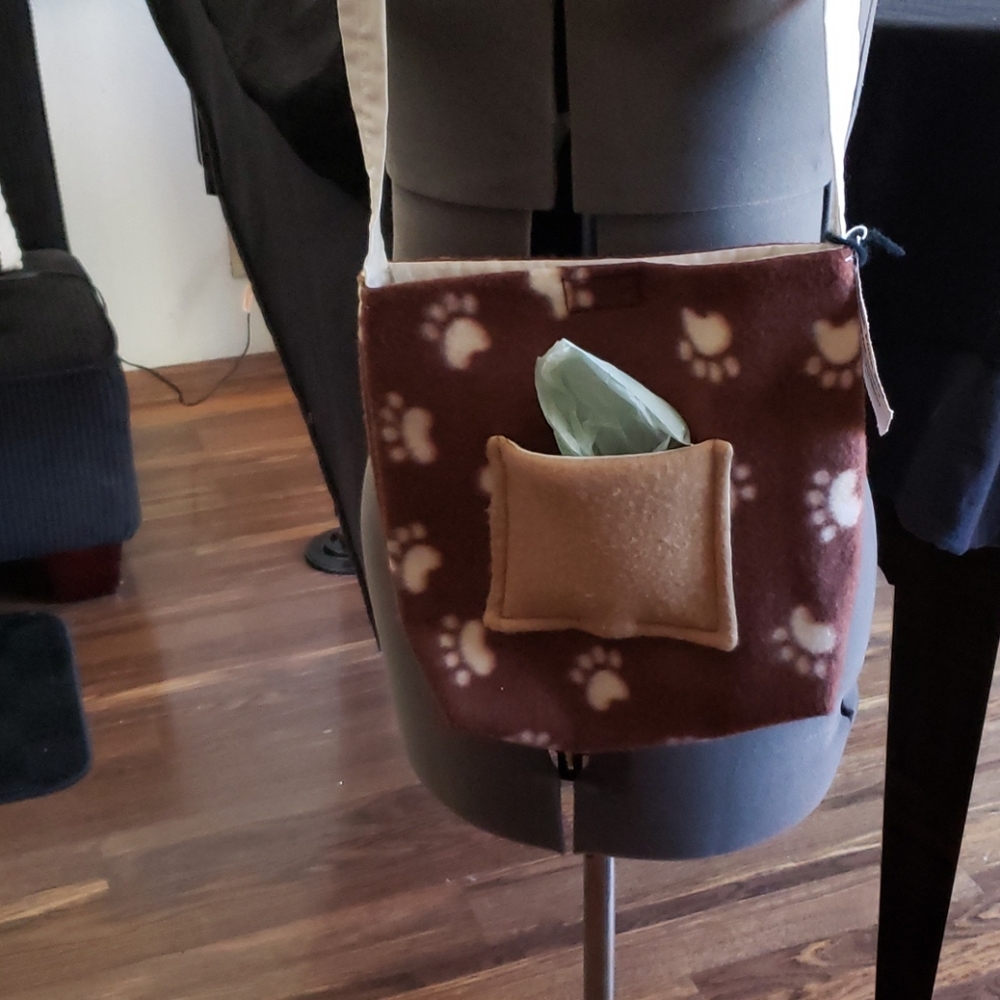 Doggie Bag with Pocket for Poop Bags and dog cap.